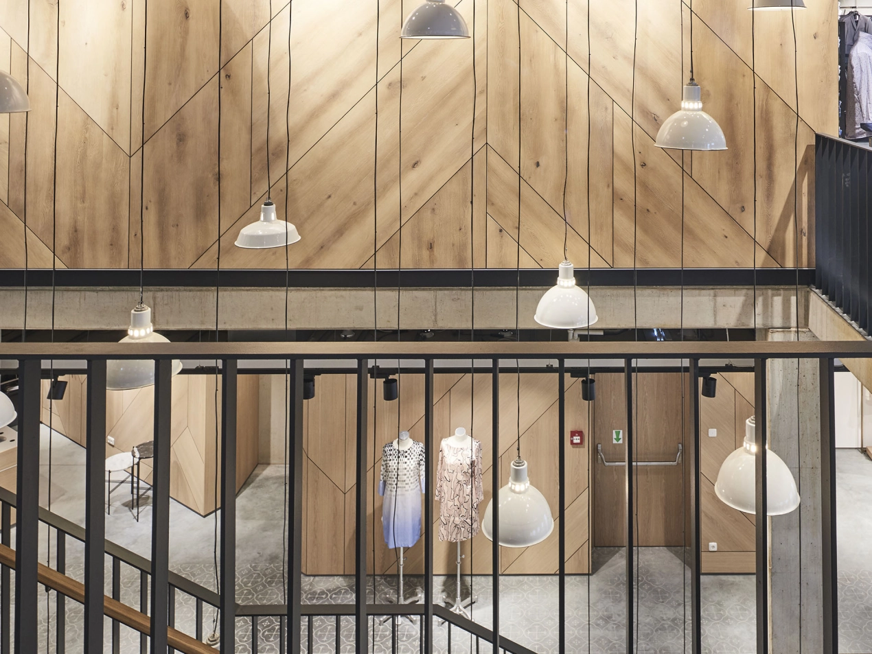 fashion store - new construction - redesign - Juhasz Bad Reichenhall - stairway - light situation - wood panel wall - hanging lamps