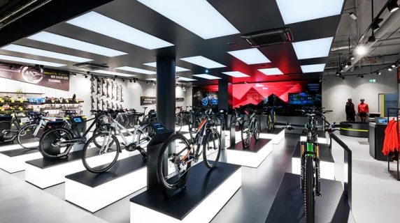 bike sports specialist store - new conception - Rose Biketown Munich - inside store overview - bike display luminescent podiums - led wall in back